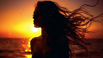 Girl s silhouette at sunset with abstractly wet hair photo