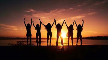 Group of friends silhouetted against a sunset photo