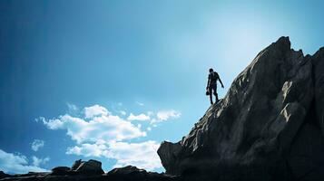 Rock climber against blue sky. silhouette concept photo