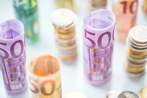 Rolled euro banknotes and coins towers stacked in other positions photo