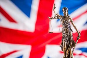 Lady Justice and United Kingdom flag. Symbol of law and justice with UK Flag photo