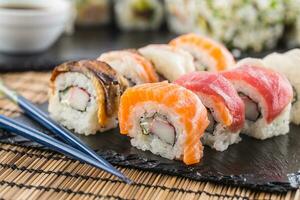 Set of roll sushi gold california with chopsticks and soy sauce. photo