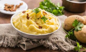 Mashed potatoes in bowl decorated with parsley herbs. photo