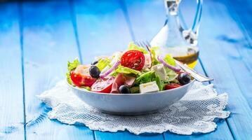 Salad. Fresh summer lettuce salad.Healthy mediterranean salad olives tomatoes parmesan cheese and prosciutto photo