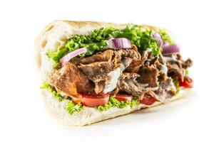 Isolated Turkish kebab baguette with generous portion of vegetables and properly grilled veal or chicken meat photo