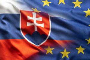 Flags of Slovak Republic and EU blowing in the wind photo