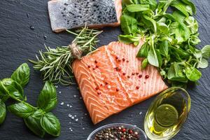 Raw salmon fillet with rosemary basil olive oil salt and pepper photo