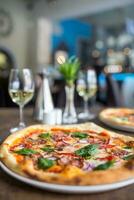 The served dinner table with pizza in pizzeria or  restaurant. photo