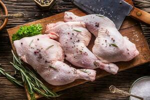 Chicken legs. Raw chicken legs with salt pepper and herbs. photo