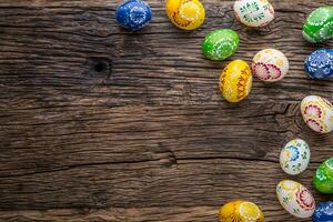 Easter. Hand made easter eggs on old wooden table. photo