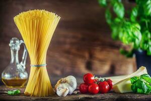 Spaghetti. Pasta spaghetti with basil garlic tomatoes cheese parmesan and olive oil photo