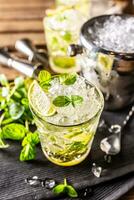 Mojito or virgin mojito long rum drink with fresh mint, lime juice, cane sugar and soda photo