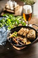 Typical Czech food svickova na smetane with dumplings and a draft pilsener beer in a glass photo