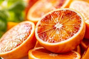 Blood sicilian oranges sliced with fresh melissa - close up photo