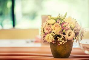 Wedding table setting. Beautiful table set with flowers and glass cups  for some festive event, party or wedding reception photo