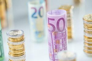 Rolled euro banknotes and coins towers stacked in other positions photo