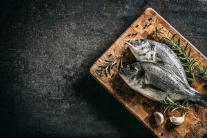 Mediterranean fish bream with spices salt herbs garlic and lemon. Healthy seafood. Concept of healthy sea food photo