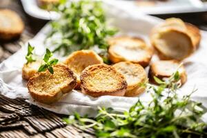 Crispy goldish bake rolls with savory flavour, served with lovely green thyme photo