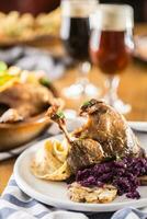 Roasted christmas duck leg red cabbage dumplings liver draft beer and baked buns photo