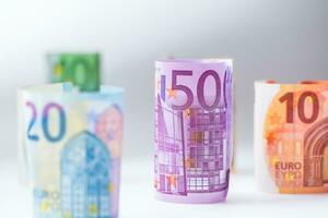 Several hundred rolls of euro banknotes in different positions. Euro money concept photo