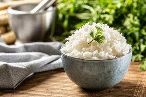 Cooked rice in a bowl with fresh parsley photo