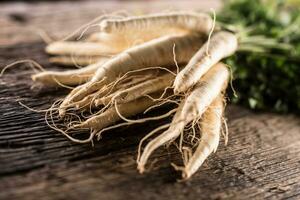 Close-up parsnip with parsley top on wooden board photo