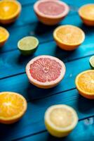 Oranges limet lemon and grapefruit on blue table. photo