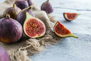 A few figs freely lying on old wooden table photo