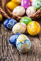 Easter. Hand made easter eggs on old wooden table. photo