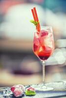 Strawberry lemonade or alcoholic cocktail  on bar table. photo