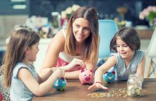 Happy Family mom daughter save money piggy bank future investment savings photo