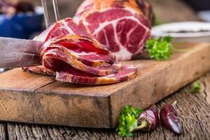 Pork meat.Pork chop smoked. Traditional smoked meat on oak wooden table in other positions photo