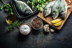 Mediterranean fish bream with spices salt herbs garlic and lemon. Healthy seafood. Concept of healthy sea food photo