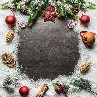 Christmas star spruce branches and decorations on snow. photo