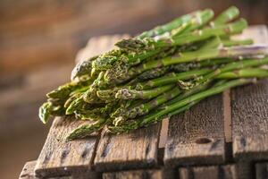 Fresh green asparagus lying on a wooden box photo