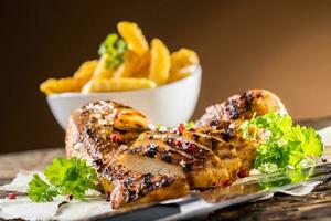 Grill chicken breast salt pepper parsley herbs and french potato fries photo