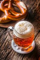 Beer and Oktoberfest. Draft beer pretzel and blue checkered tablecloth as traditional products for bavarian festival oktoberfest photo