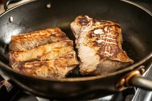 Finely roasted wild boar meat on a pan for a hunting dinner photo