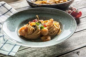 pasta espaguetis en plato y pan con camarón tomate salsa Toatoes y hierbas. italiano o Mediterráneo cocina foto