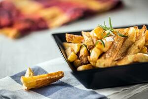 Potato Fries. Homemade potato fries with salt and rosemary photo