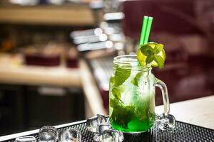 Mojito drink or lemonade with mint leaves on barcounter. photo