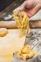 The chef's hands prepare dough for pasta photo