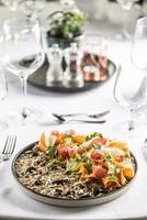 Italian creamy brown mushroom risotto with variations of root vegetables slices as salad on the side photo