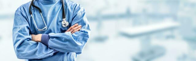 Young doctor surgeon specialist with scalpel. In the background blurred the interior of the operating room photo