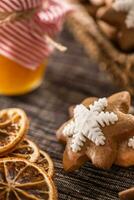 Gingerbread christmas cookies with jar of honey on kitchen table - Close-up photo