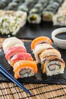 Set of roll sushi gold california with chopsticks and soy sauce. photo