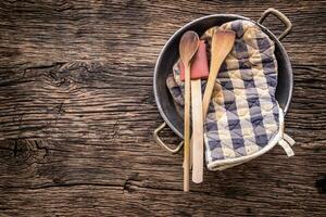 Top of view on Vintage kitchen utensils on rustic wood background. photo