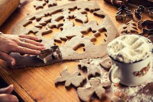 Gingerbread dough and woman hands preparing christmas biscuit cakes photo