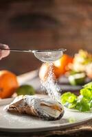 Sicilian Cannoli sweet dessert topped with sugar on a rustic background photo