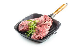 Beef meeat Rib-Eye steak wit rosemary salt and pepper in grill pan isolated on white photo